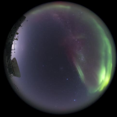 fisheye view of green Aurora Australis illuminating the starry sky