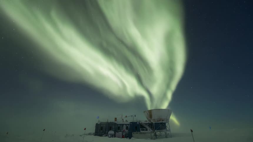 Scientific center in antarctica with the sky full of Aurora Australis