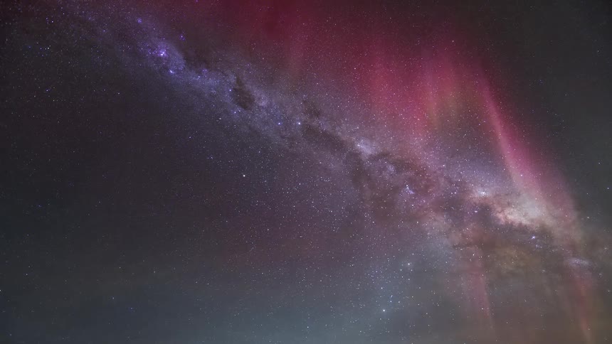 Starry sky landscape with greenish and purple Aurora Australis