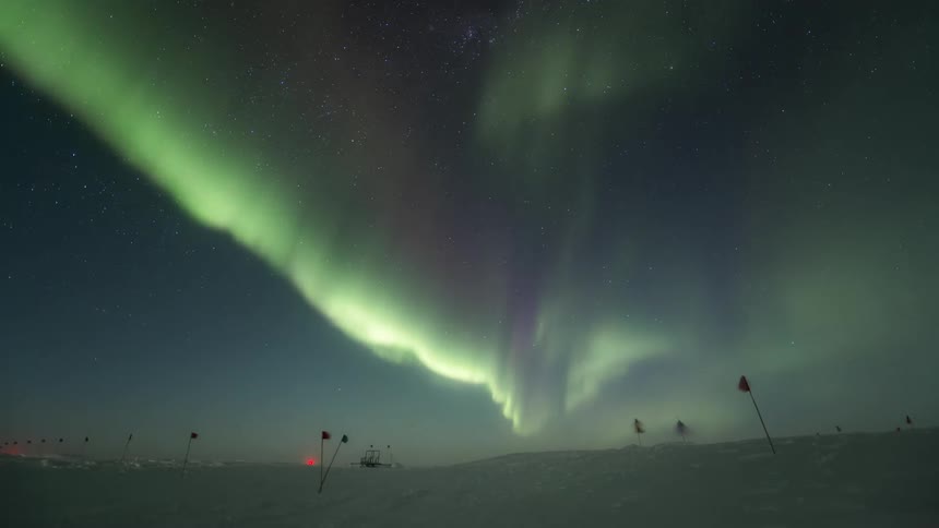 Ground covered by snow on a night with the Aurora Australis