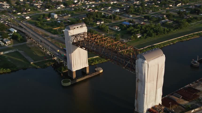 Aerial of a bridge over the river in a residential neighborhood