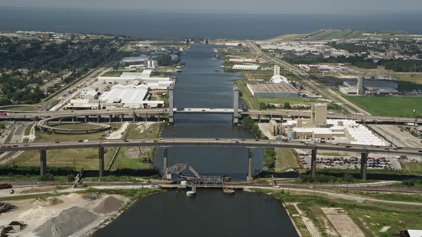 Aerial panorama of an urban city with a factories waterfront bridge