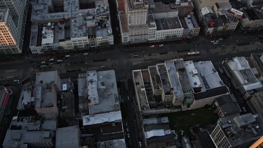 A road with traffic runs through a city