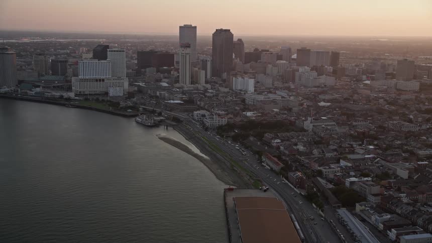 Aerial panorama of a metropolis with a skyscraper next to a sea canal in a morning