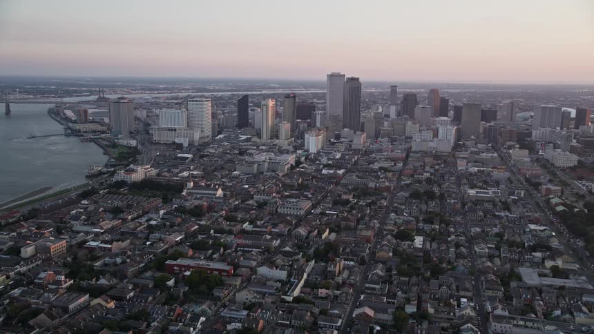 Multiple tower blocks dominate a city with a waterfront