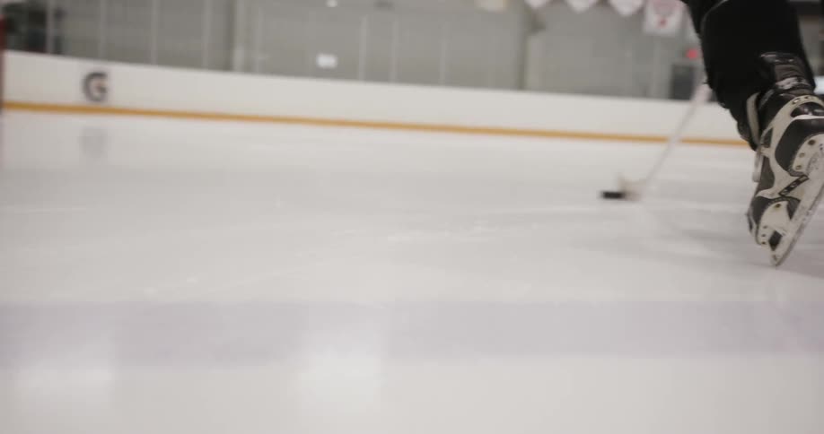 A hockey player is skating on the ice
