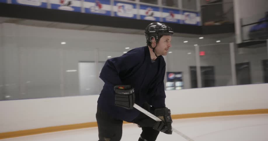 A man is playing ice hockey by himself