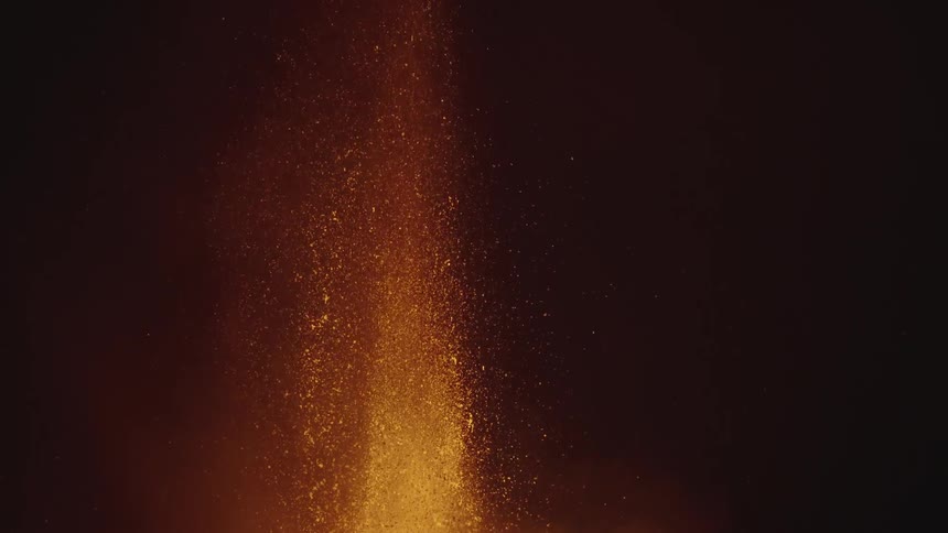 Hot glowing lava sprays into the air as a volcano erupts
