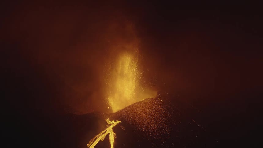 Panorama of an erupting volcanic crater at night