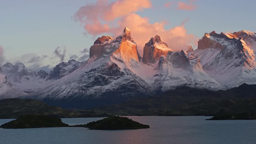 A region like mountains covered in snow and in front there is a huge lake