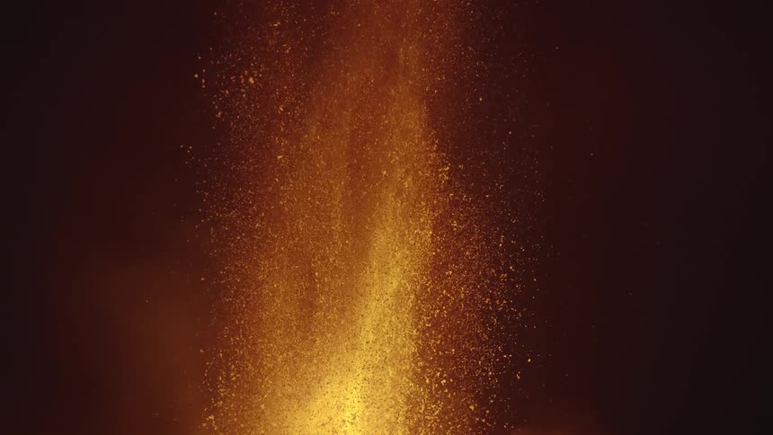 Lava from a volcano erupts at night