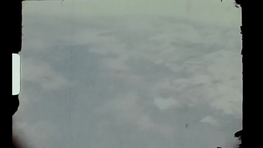 An aerial view from an airplane window of the clouds