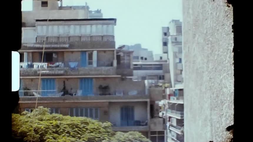 People walk around the apartment buildings