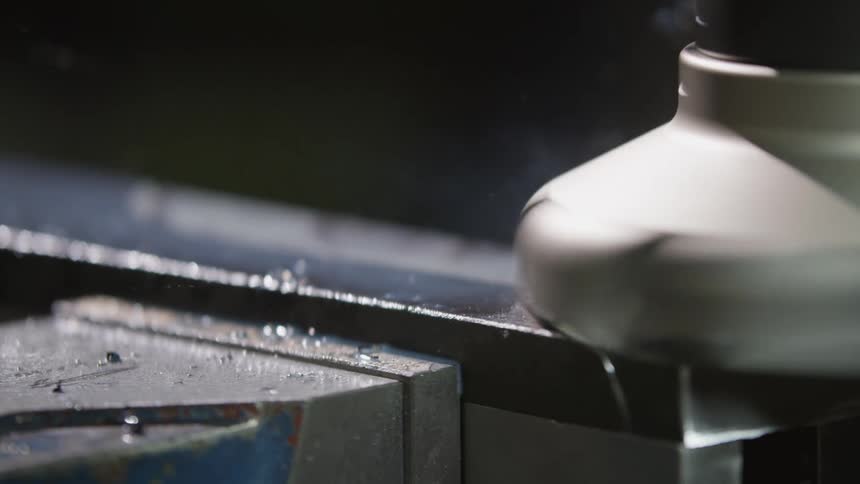 The machine is spraying metal shavings