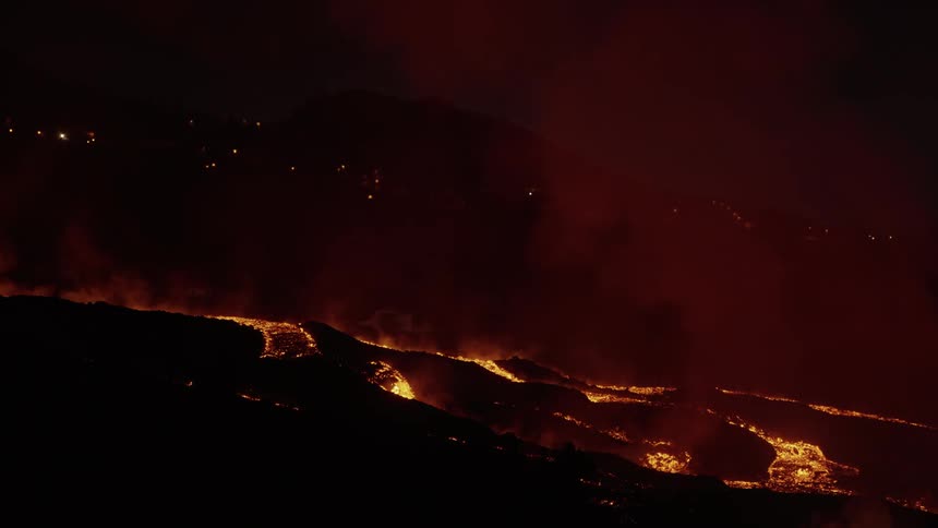 Forests burn due to lava flows from a volcano