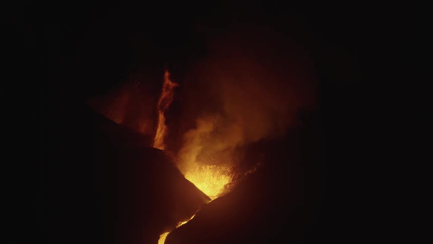 Volcano erupting at night