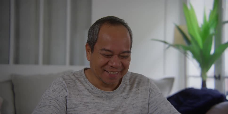 Portrait of a man drinking a cup and then holding hands with a smiling person