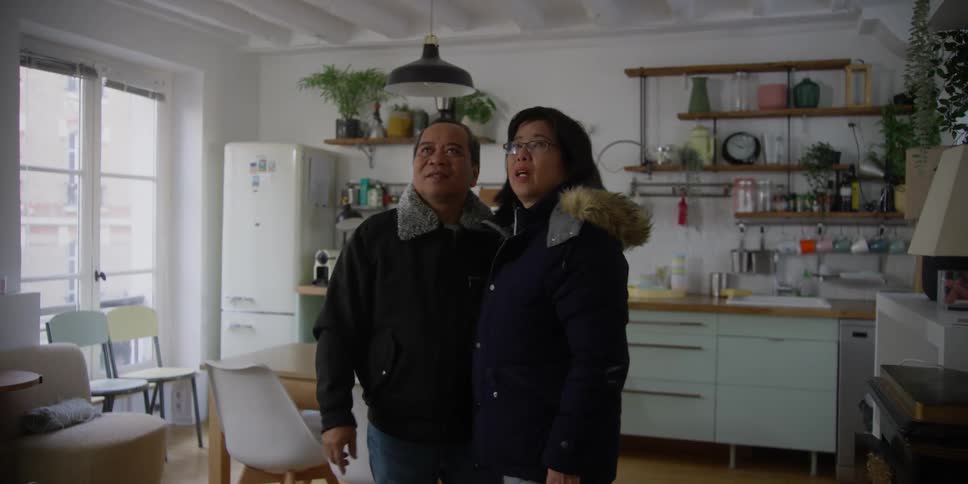 A couple point and talk in the kitchen