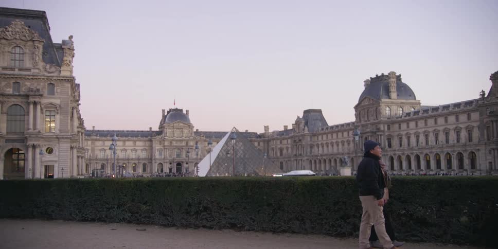 Tourists hold hands while walking
