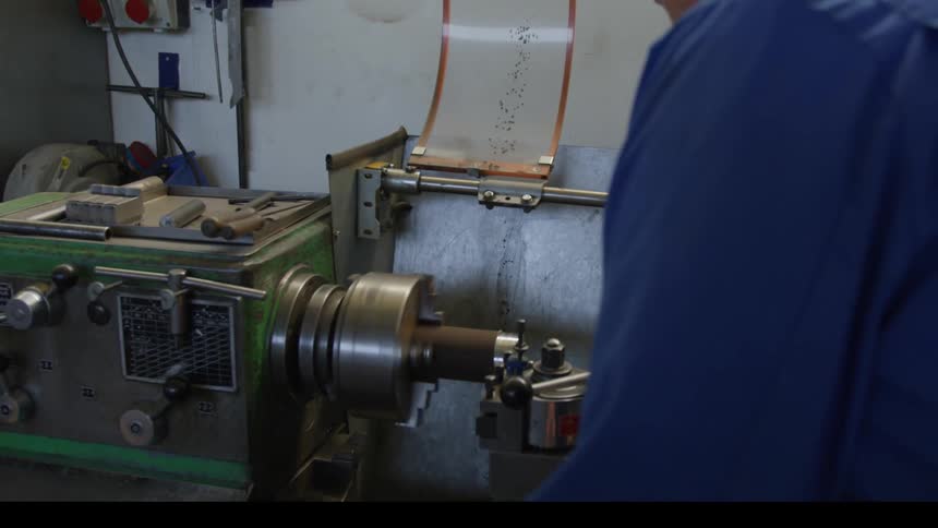 A man is using a machine in the factory