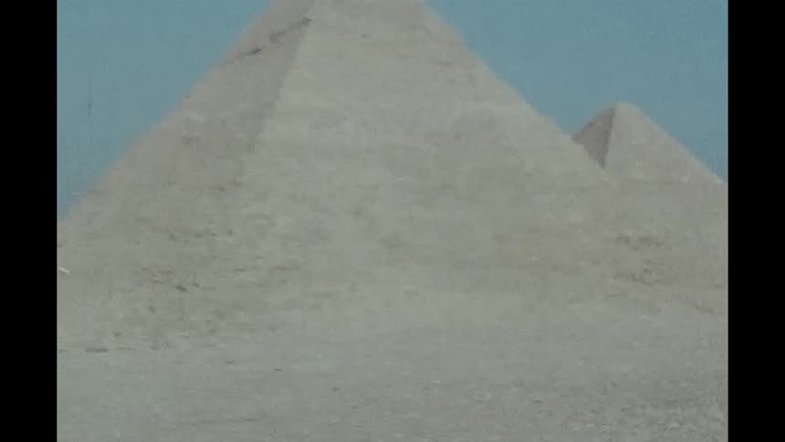 Pyramids in egypt with its stone blocks and clear sky in focus caught on vintage film
