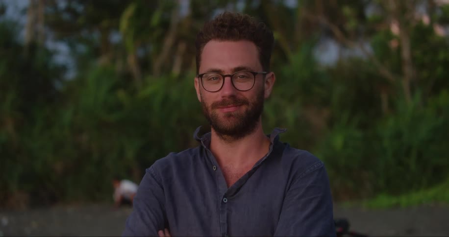 A man is smiling outside