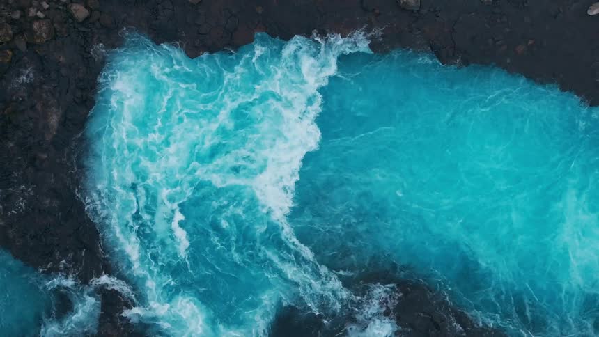 Water tumbles into a space that makes waves