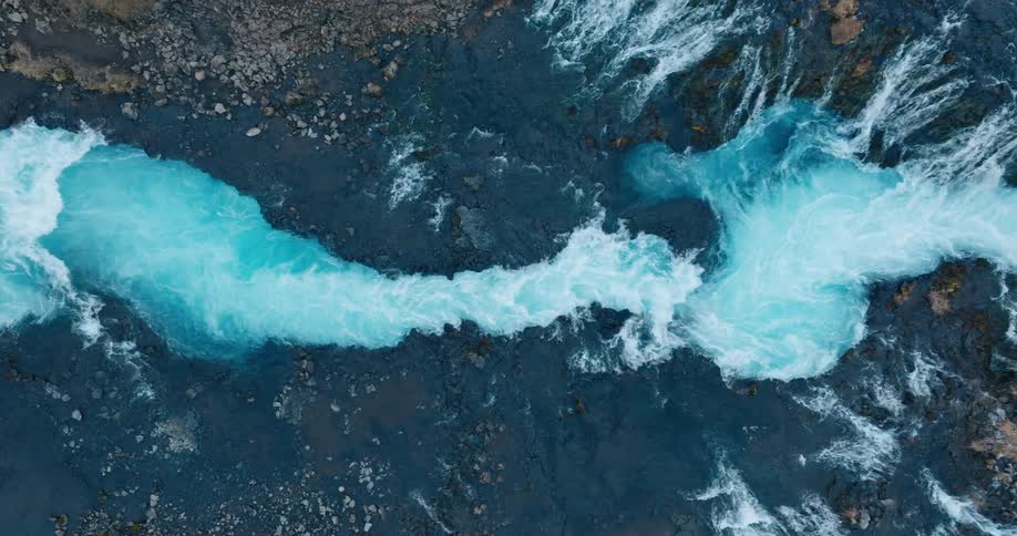 Several waterfalls tumble over rocks
