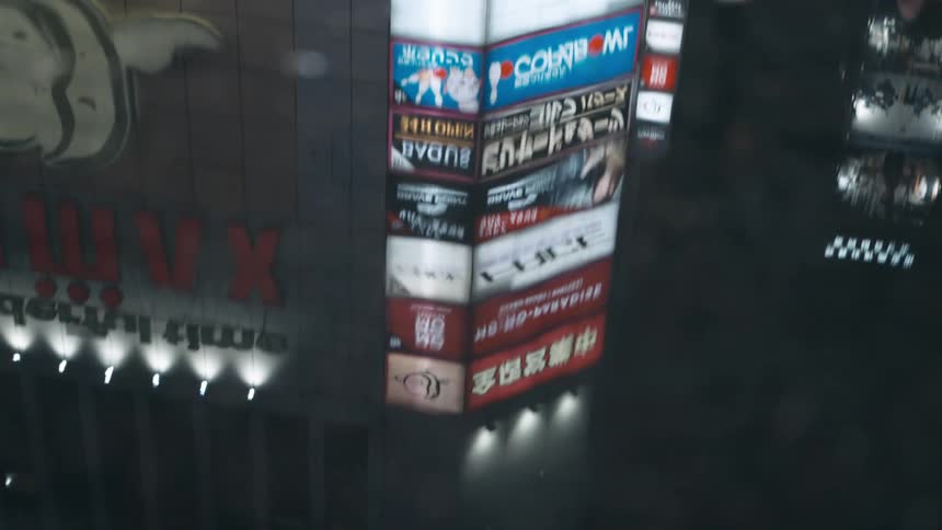 Numerous lighted signs reflected in a pool of water