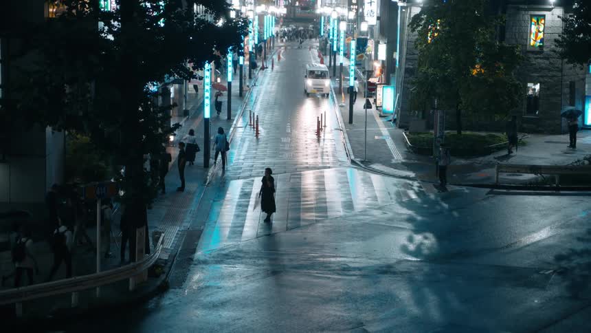 Pedestrians walk in Tokyo at night