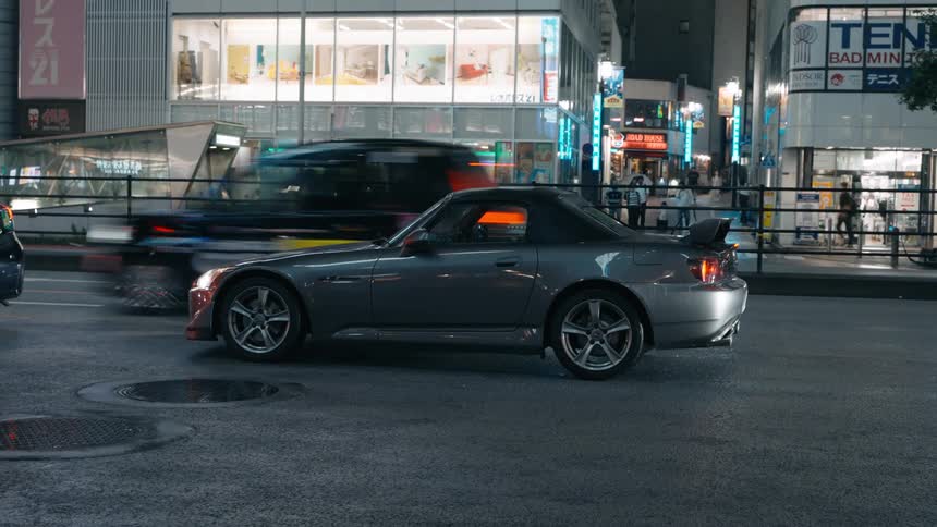 A car passes another car in the streets of Tokyo