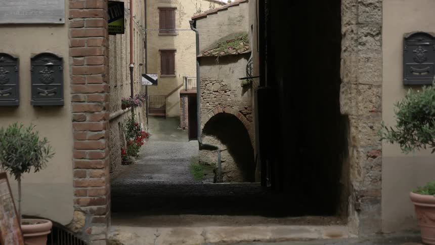 Narrow passageway between buildings as seen through an opening