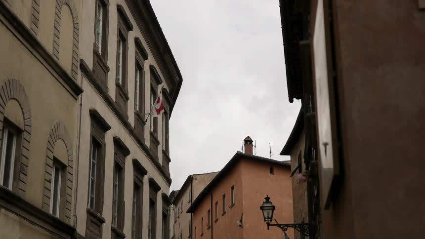 A flag breezes in the wind outside a window