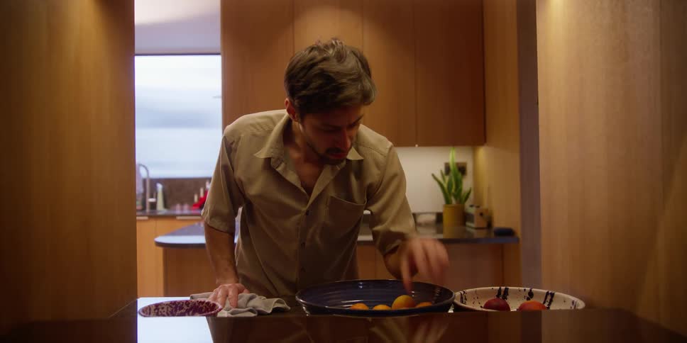 A man cleans a kitchen counter