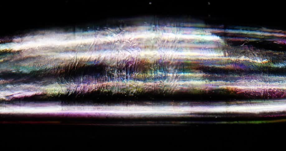 Light reflects off the colored liquid