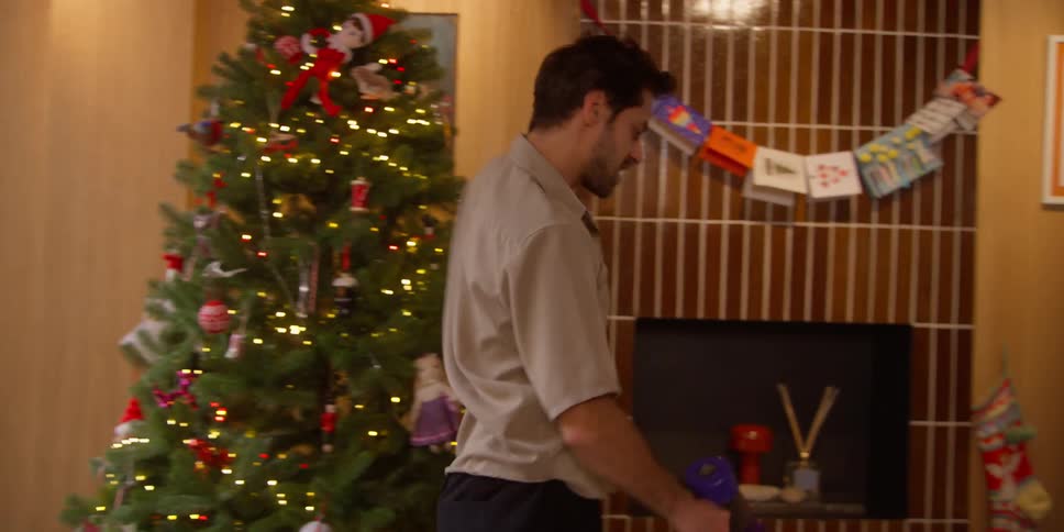 A man is vacuuming his home