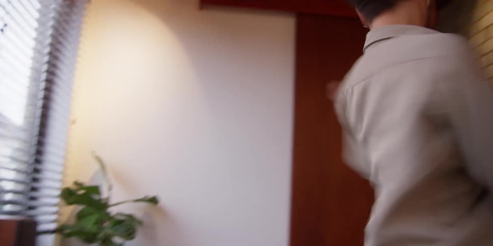 A man dances while cleaning a table
