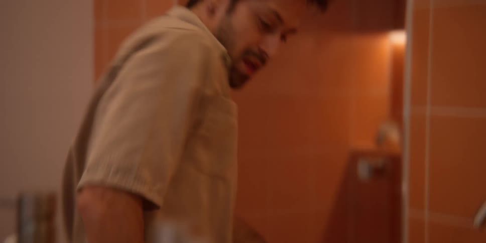 Young man dances while cleaning the bathroom sink