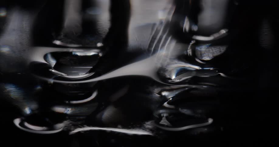 Spots of iridescent color contrast with predominately black and white of mixture