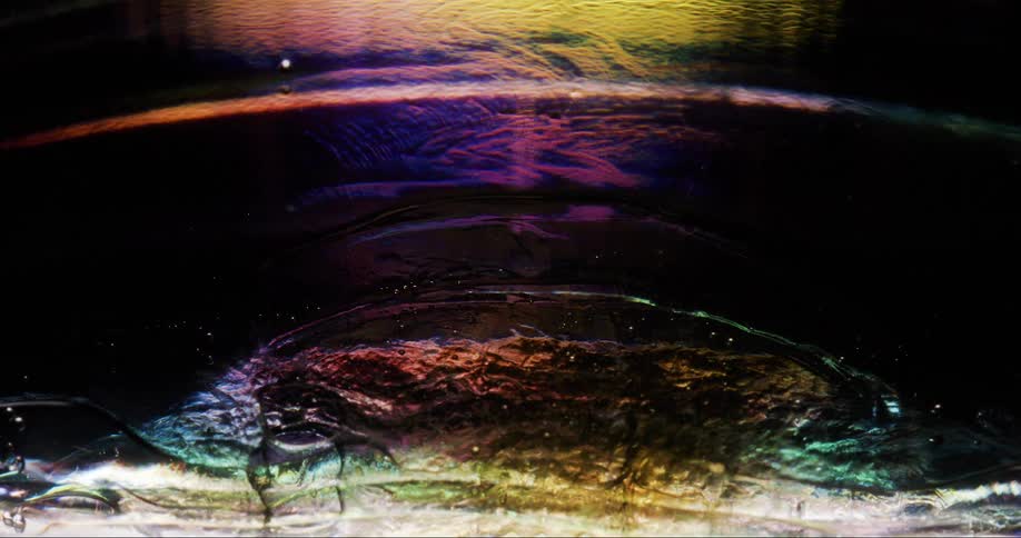 Texture of a dense and shiny liquid in abstract movement and slow motion