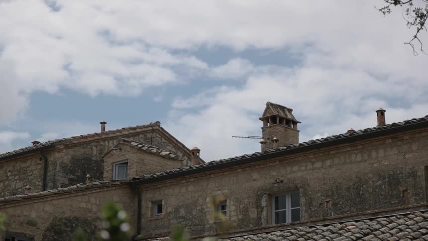 A stone building on a partly cloudy day
