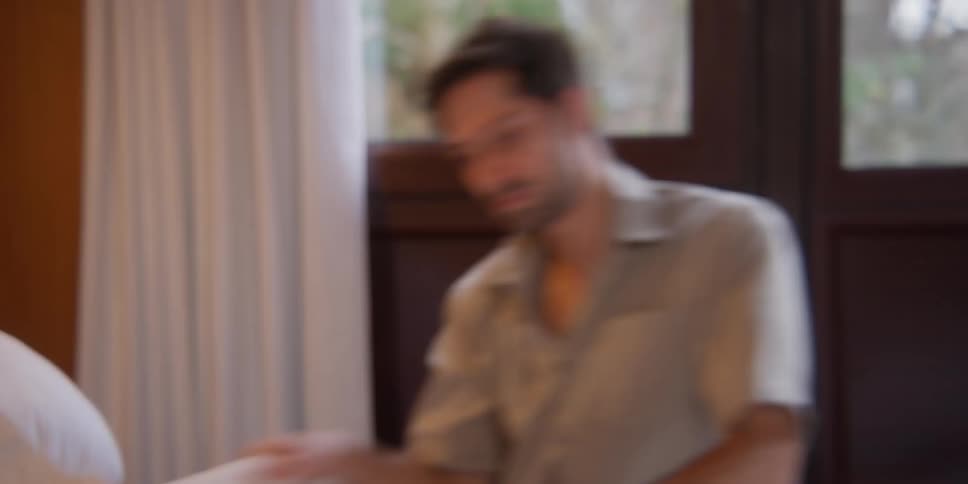 Man while arranging the bed dances in an artistic way