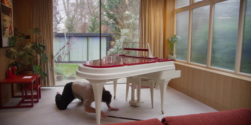 A man dances while cleaning the room