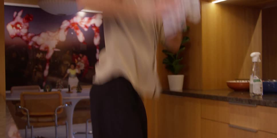 Man mopping in the kitchen while dancing
