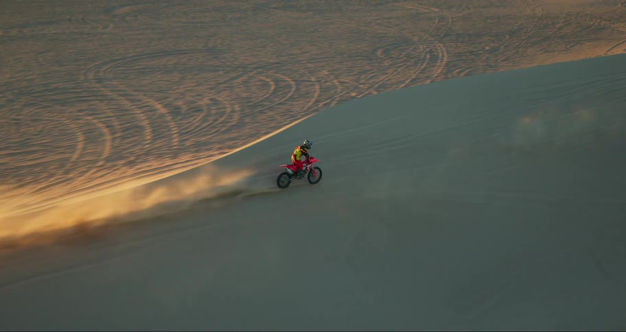 Two motorcycles racing in the desert