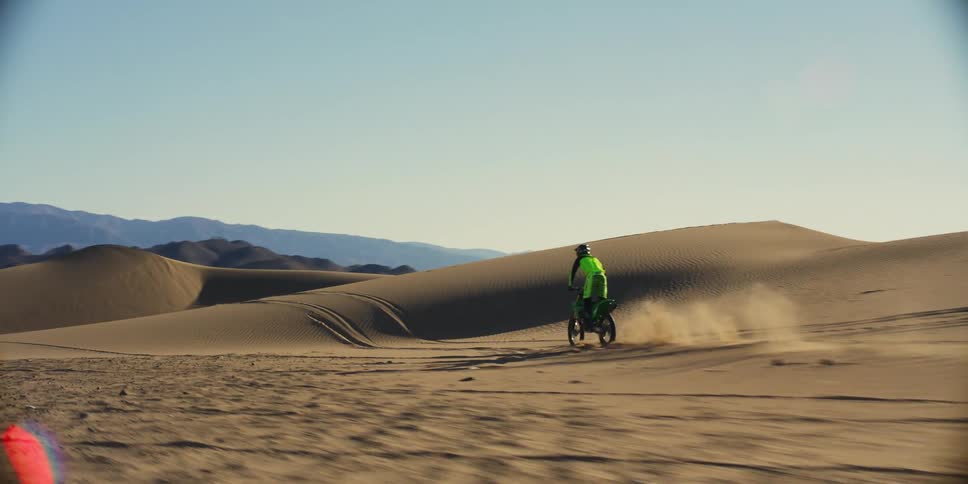 Two motorcycles racing in the desert