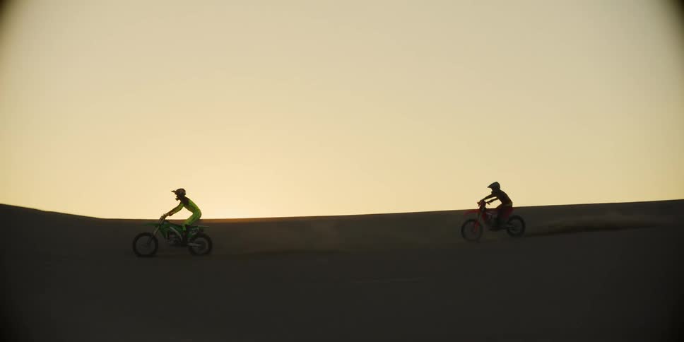 Two motorcycles racing in the desert