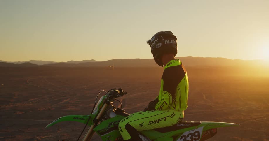Two men sit on their dirt bikes
