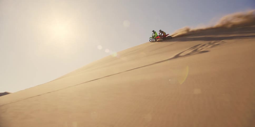 Two motorcycles racing in the desert