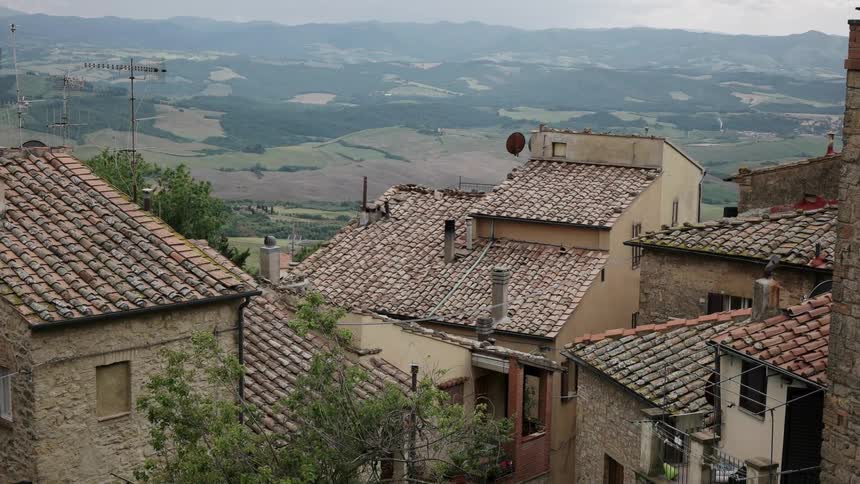 Village rooftops stand overlooking a valley